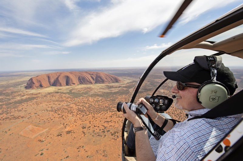 Man taking a photo over Uluru