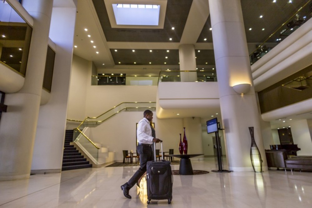 Man checking into Hilton lobby