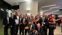 image of men and women dressed in suits and gowns at awards night