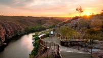 A couple stand and watch the sunset on a platform overlooking Katherine Gorge, Nitmiluk National Park