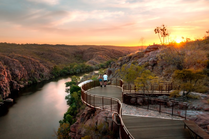 A couple stand and watch the sunset on a platform overlooking Katherine Gorge, Nitmiluk National Park