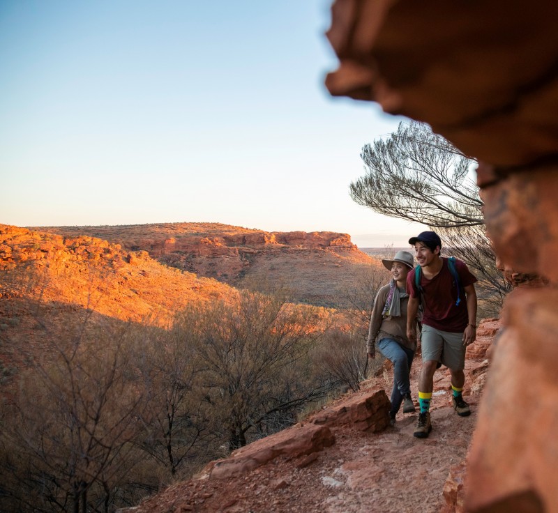 image of woman and man hiking with rocks