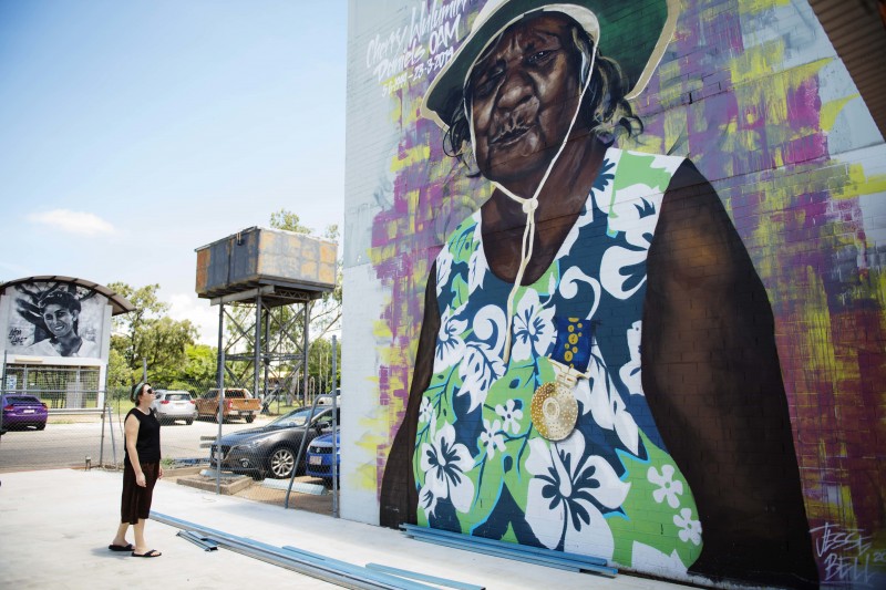 woman looking up at mural of woman in katherine