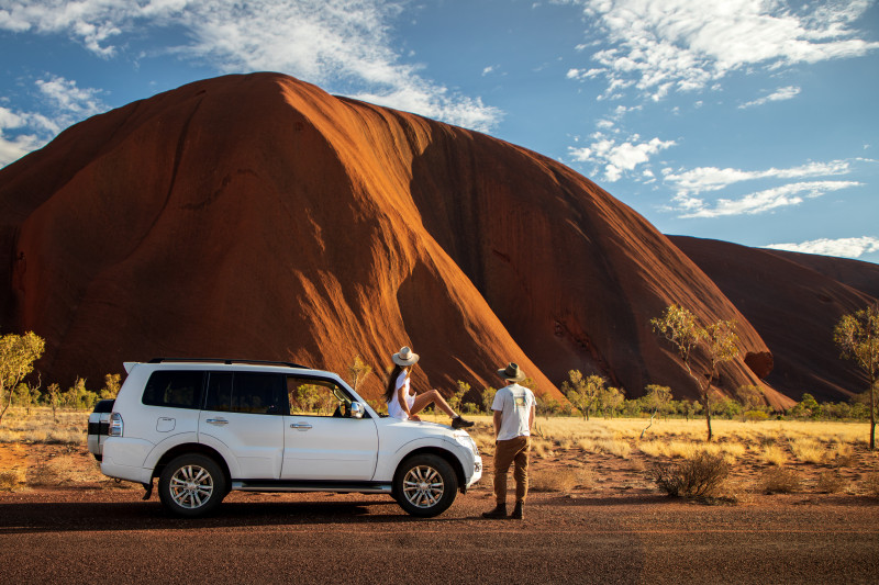 Tourists parked at the base of Uluru